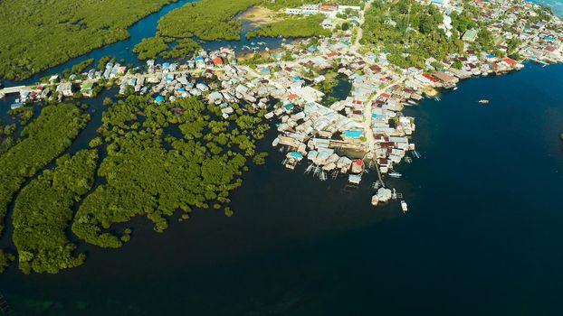 Village near mangroves in the bay of the ocean, top view. Siargao island, Philippines.