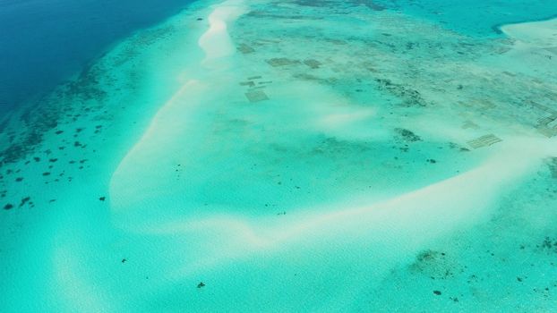 Sandy beach with among turquoise waters and coral reefs. Mansalangan sandbar. Beach at the atoll. Summer and travel vacation concept. Balabac, Palawan, Philippines.