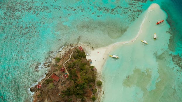 aerial seascape tropical island and sand beach, turquoise water and coral reef. malacory island, Philippines, Palawan. tourist boats on coast tropical island.