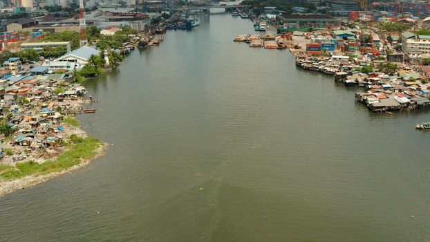 Slum area in Manila, Phillippines, top view. lot of garbage in the water.