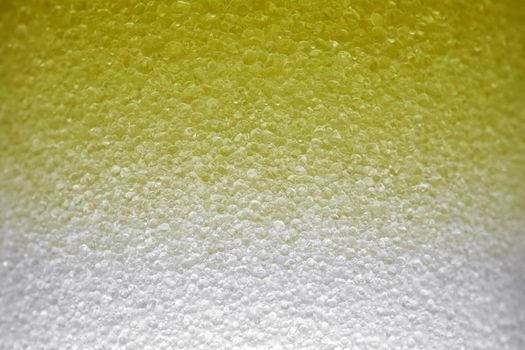 yellow bubbles of micellar water macro as background. high-quality photos