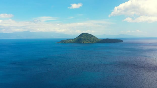 Island with a white beach, top view. Atulayan Island, Camarines Sur, Philippines.Sea landscape, blue sea and tropical island with a jungle. Summer and travel vacation concept.