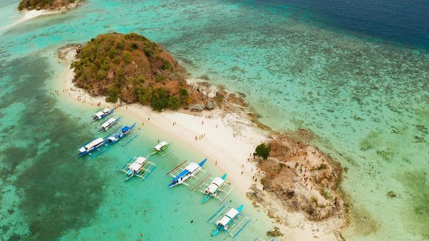 aerial view tropical island with sand white beach. Bulog Dos, Philippines, Palawan. Seascape bay with turquoise water and coral reef.