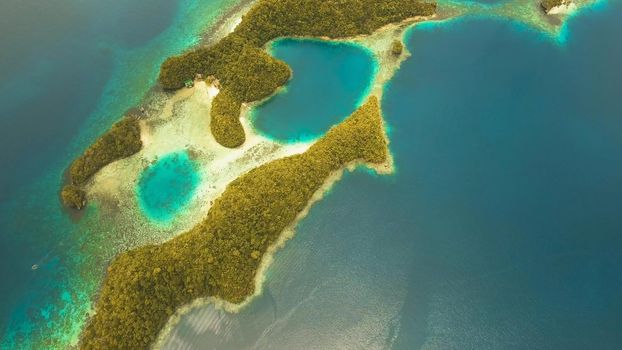 Aerial view: Bucas Grande Island, Sohoton Cove. Philippines. Tropical sea bay and lagoon, beach. Tropical landscape hill, clouds and mountains rocks with rainforest. Azure water of lagoon. Shore Landscape Bay. Aerial video.Seascape. Travel concept.