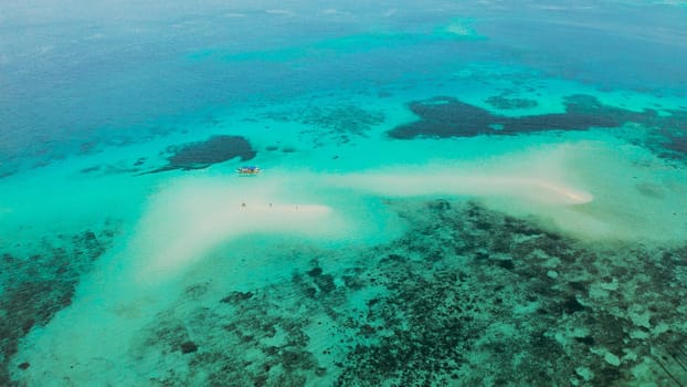 Seascape: Sandy bar, beach among coral reefs in turquoise atoll water, top view. Summer and travel vacation concept. Balabac, Palawan, Philippines.