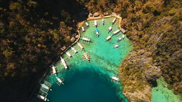 Tropical lagoon with azure water, beach by the Kayangan Lake, Philippines. Aerial view Coron island, with cove, bay at Kayangan lake. Lagoon with sailing boats. Aerial video. Philippines. Travel concept
