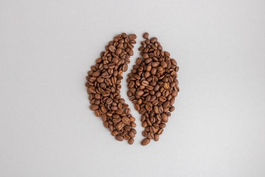 Coffee beans. Isolated on a gray background in the shape of a coffee bean.