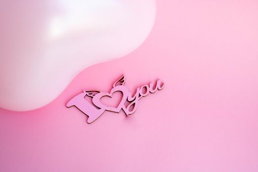 Pink balloon in the shape of a heart on a pink background, with a sign I love you. Wedding concept, Valentine's Day, photo zone, lovers. Banner. top view. Place for your text.