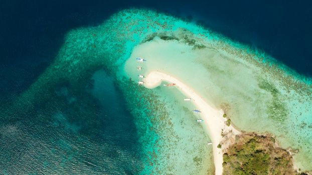 aerial seascape tropical island with sand bar, turquoise water and coral reef. Ditaytayan, Palawan, Philippines. tourist boats on tropical beach. Travel tropical concept. Palawan, Philippines