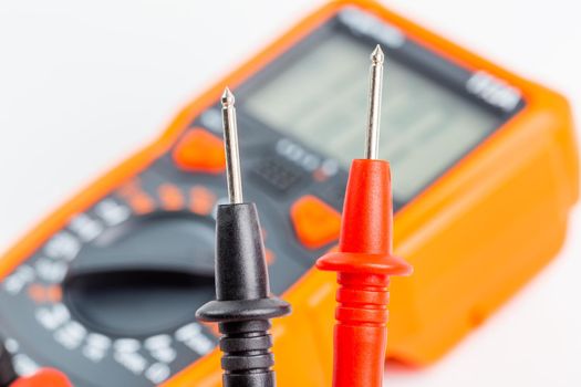 close-up view of digital electrical multimeter probe tips with selective focus and natural background blur