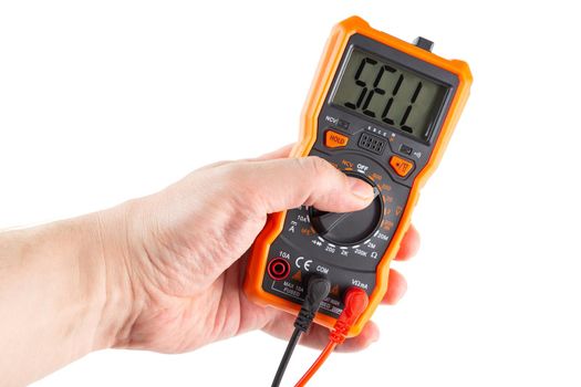 the word sell indicating on monochrome LCD screen of digital electrical multimeter in bare left caucasian hand, isolated on white background with selective focus