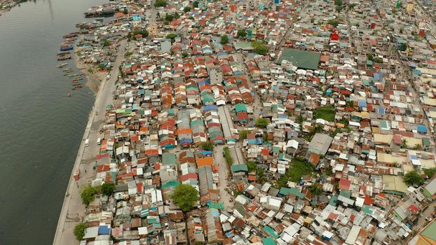 Slum area in Manila, Phillippines, top view. lot of garbage in the water.