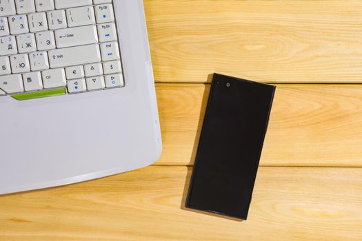 laptop on a wooden background top view. High quality photo