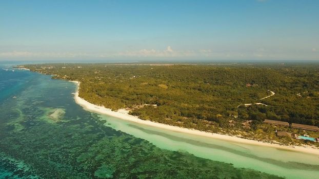 Aerial view of tropical beach on the island Bohol, Philippines. Beautiful tropical island with sand beach, palm trees. Tropical landscape: beach with palm trees. Seascape: Ocean, sky, sea . Philippines.Travel concept.