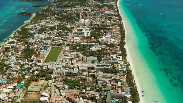 Tropical island Boracay with sandy beach and hotels view from the sea, aerial view. Summer and travel vacation concept. Philippines