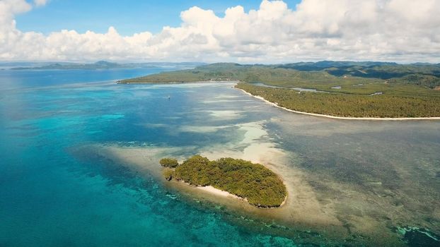 Aerial view of beautiful tropical island with sand beach, azure water. Seascape:Tropical lagoon with turquoise water. Beautiful tropical beach on the island. Philippines. Travel concept.