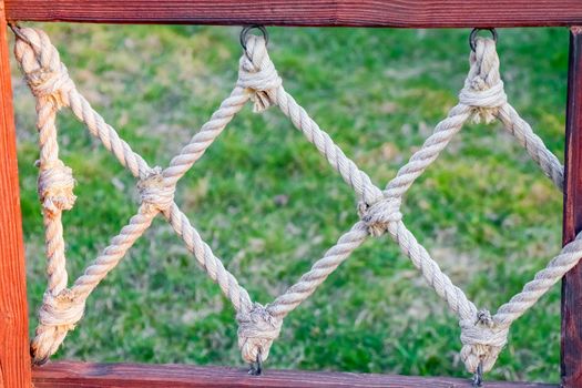 rope tied in a wooden frame as background. High quality photo