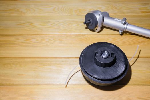 the grass trimmer. details on a wooden background.the view from the top. High quality photo