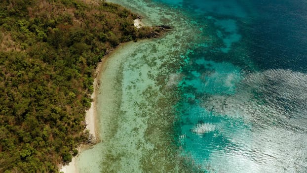 aerial view tropical island Bulalacao with blue lagoon, coral reef and sandy beach. Palawan, Philippines. Islands of the Malayan archipelago with turquoise lagoons.