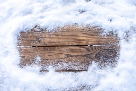 Winter background. Empty wooden plank with snowy border, copy space for text Wood table to. For product display Christmas time mock up