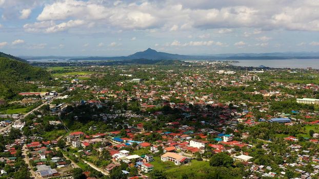 Tropical landscape with panorama of Tacloban, aerial view. Town and sky with cumulus clouds. Leyte Island, Philippines. . Summer and travel vacation concept.