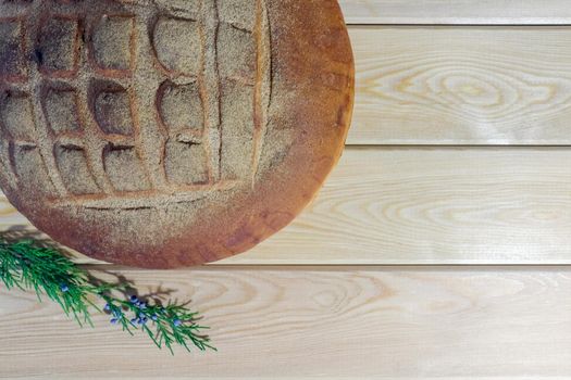 a loaf of bread on a wooden background. High quality photo