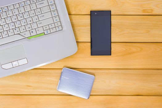 laptop on a wooden background top view. High quality photo