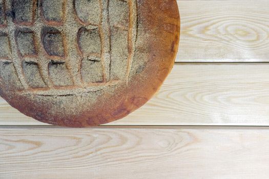 a loaf of bread on a wooden background. High quality photo