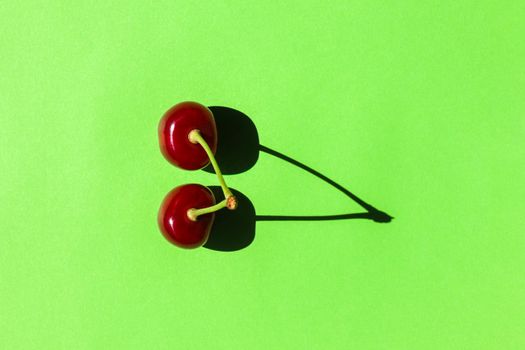 cherry berry with a hard shadow on a plain background. the view from the top. blank for the pattern. High quality photo