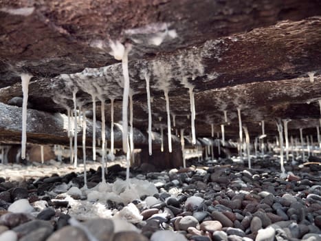 Production of sea salt in the Bali,Indonesia. Salt crystallizes out of the ground in salt farm, filled with natural salt from the sea.