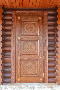 wooden carved door to a log house. High quality photo