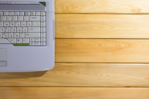 laptop on a wooden background top view. High quality photo