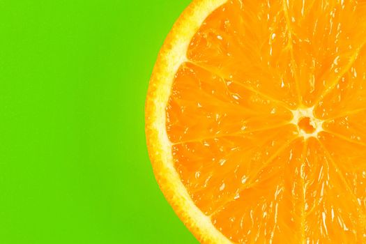 orange slice on a green background macro. place for the label. High quality photo