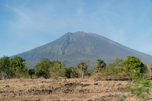 Mountain Agung, mountains covered with green forest, trees with sky and clouds. Slopes of the mountains are covered with forest in Asia. Bali,Indonesia. Travel concept.
