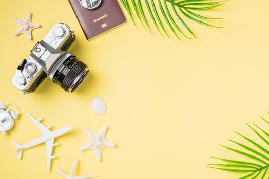 Flat lay top view mockup retro camera films, airplane, passport, starfish traveler tropical beach accessories on a yellow background with copy space, Vacation summer travel and business trip concept