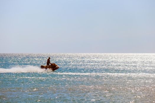a man rides a jet ski in the open sea. High quality photo