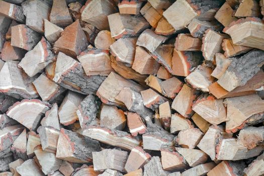 firewood chopped stacked in several layers macro. High quality photo