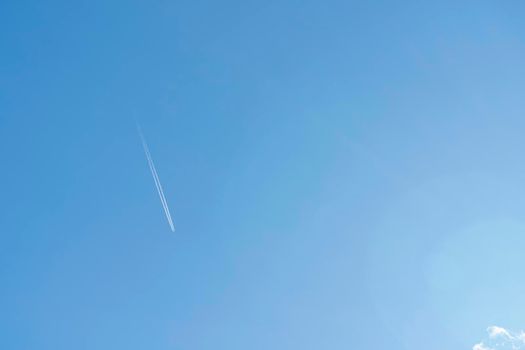 the plane and its footprint in the blue sky. High quality photo