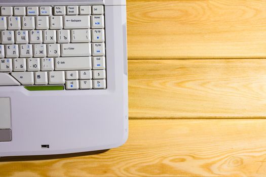 laptop on a wooden background top view. High quality photo