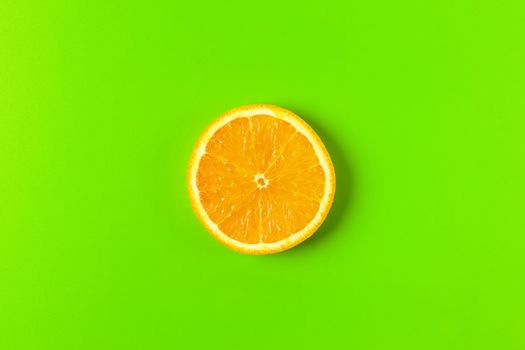orange slice on a green background macro. place for the label. High quality photo
