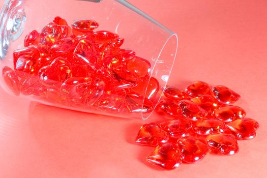 glass red hearts in a glass on a red background for Valentine's day. High quality photo