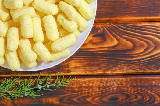 corn sticks on a plate on a wooden background. High quality photo