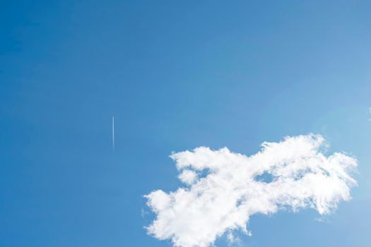 the plane and its footprint in the blue sky. High quality photo