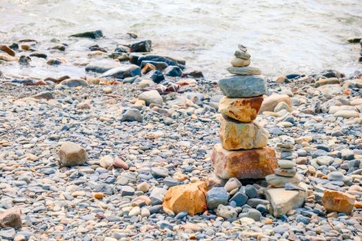 pebbles and stones on the beach. waves and splashes on the shore. High quality photo