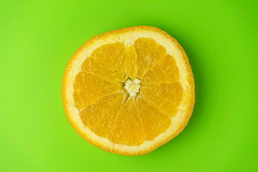 orange slice close-up. isolate on a green background. High quality photo