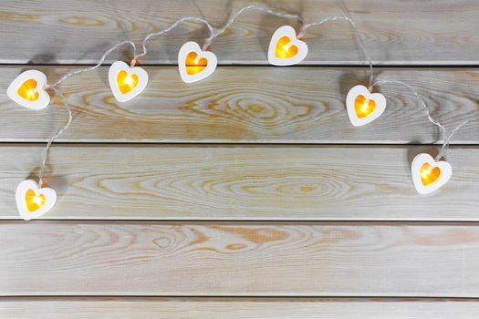 hearts garland on a wooden background top view . High quality photo