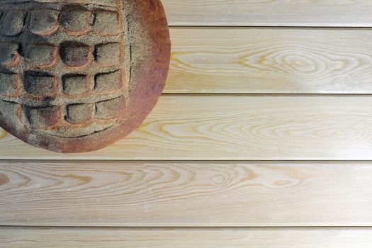 a loaf of bread on a wooden background. High quality photo