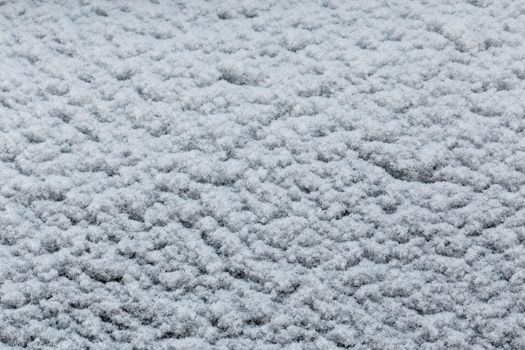 snow and frost covered car window glass surface texture and full frame background.