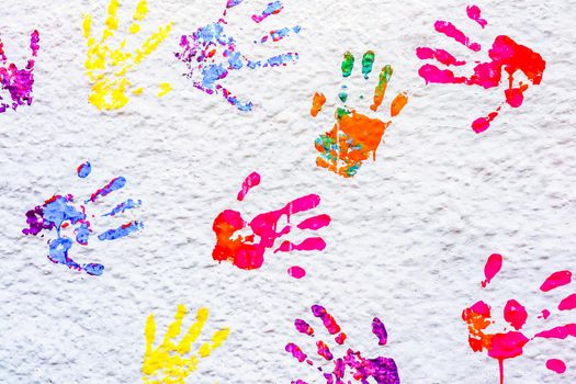 handprints paint on a white wall. High quality photo