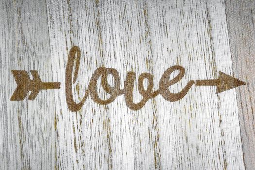 the inscription love on a wooden background top view. High quality photo